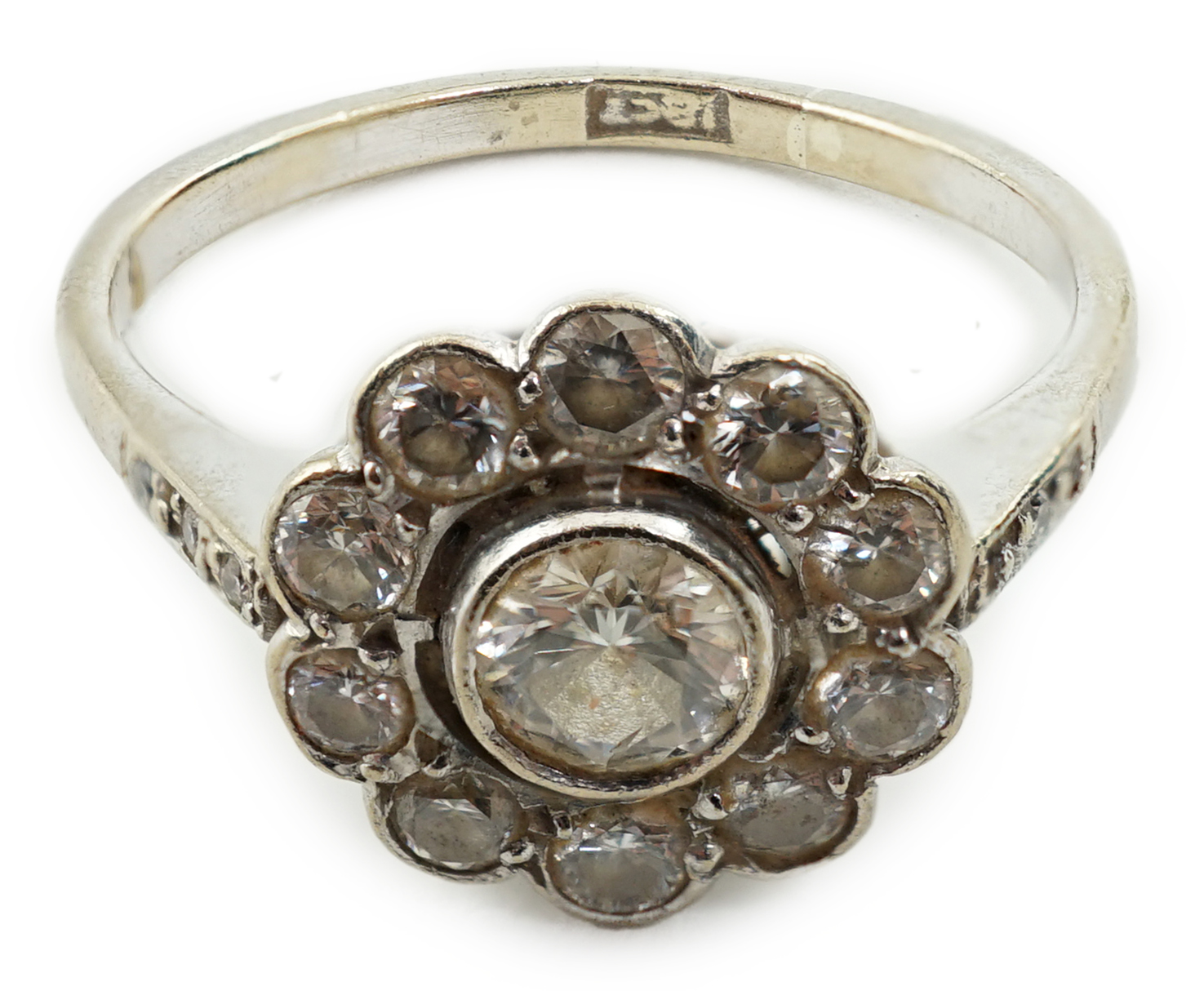 A mid 20th century 18ct white gold and eleven stone diamond set flower head cluster ring